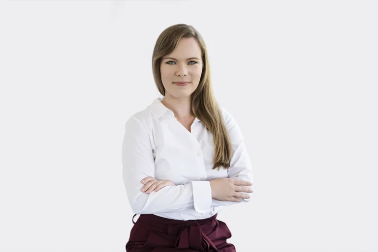 Fehér inget viselő nő karba tett kézzel pózol fehér háttér előtt önéletrajzhoz, professzionális portréfotón